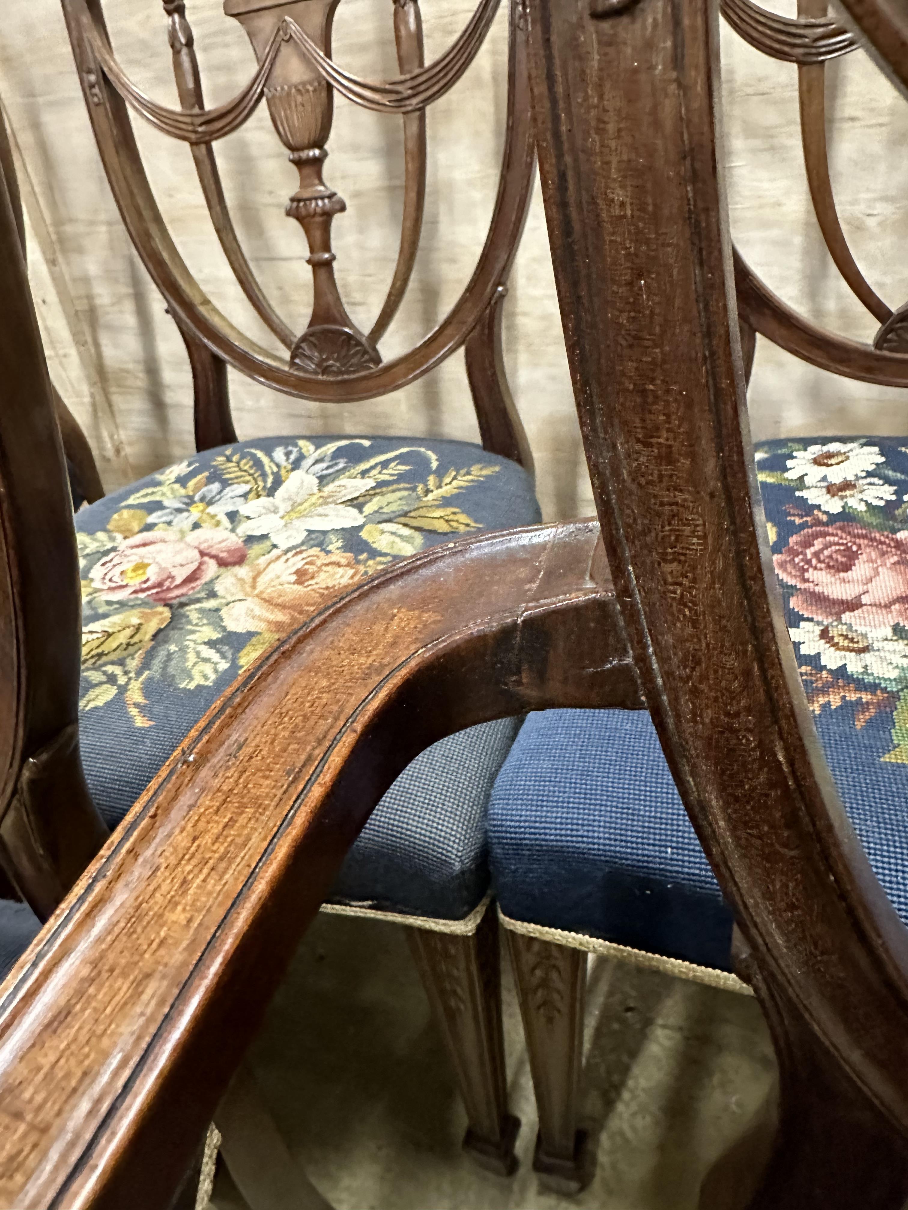 A set of eight Edwardian Hepplewhite style mahogany dining chairs with tapestry seats, two with arms